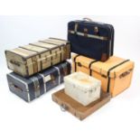 Three fibre-covered travelling trunks; together with two other trunks; & a suitcase