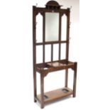 An Edwardian oak hallstand, inset rectangular mirror to back above glove compartment, & on square