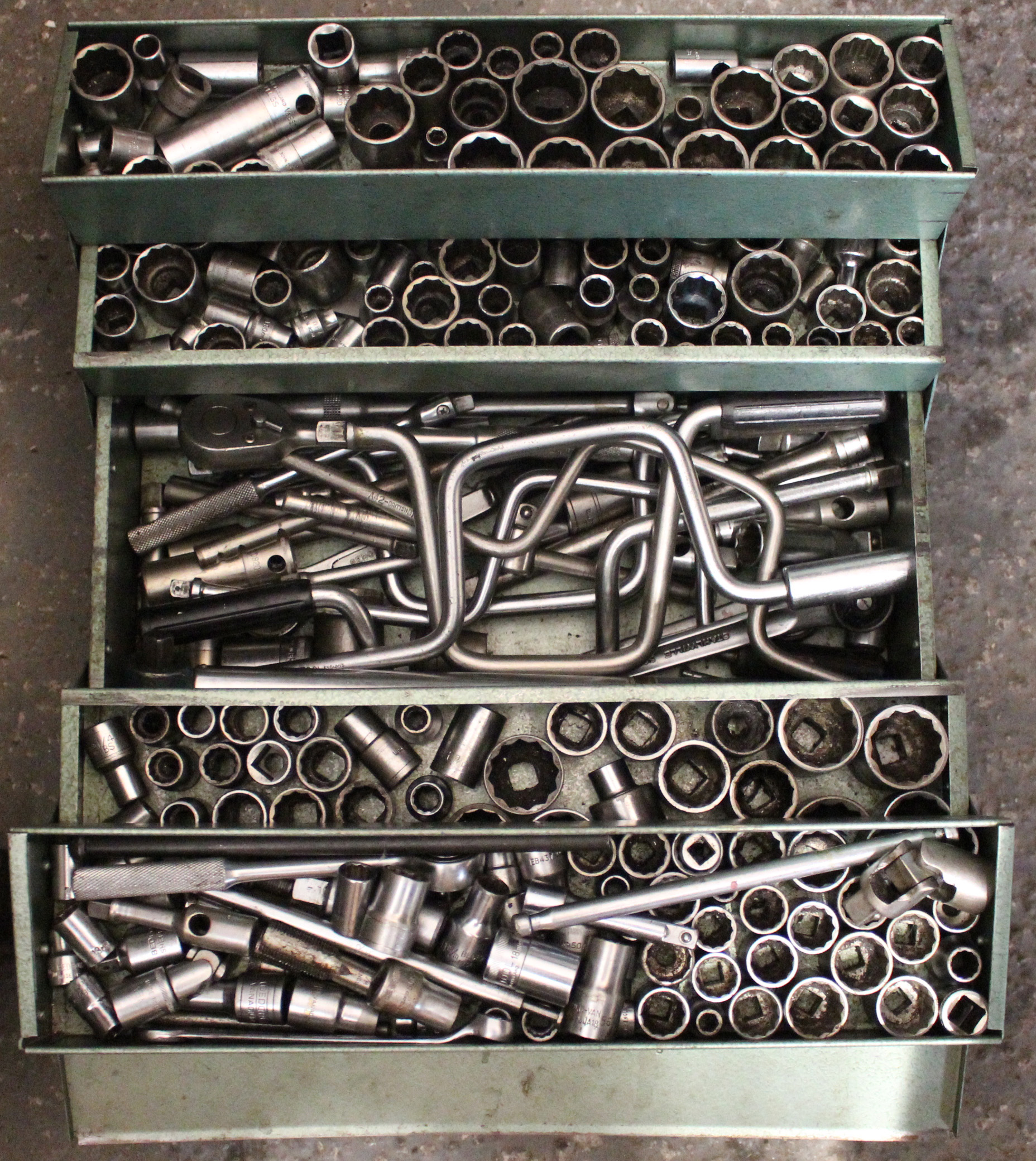 Two metal cantilever tool boxes containing numerous spanners & socket sets.