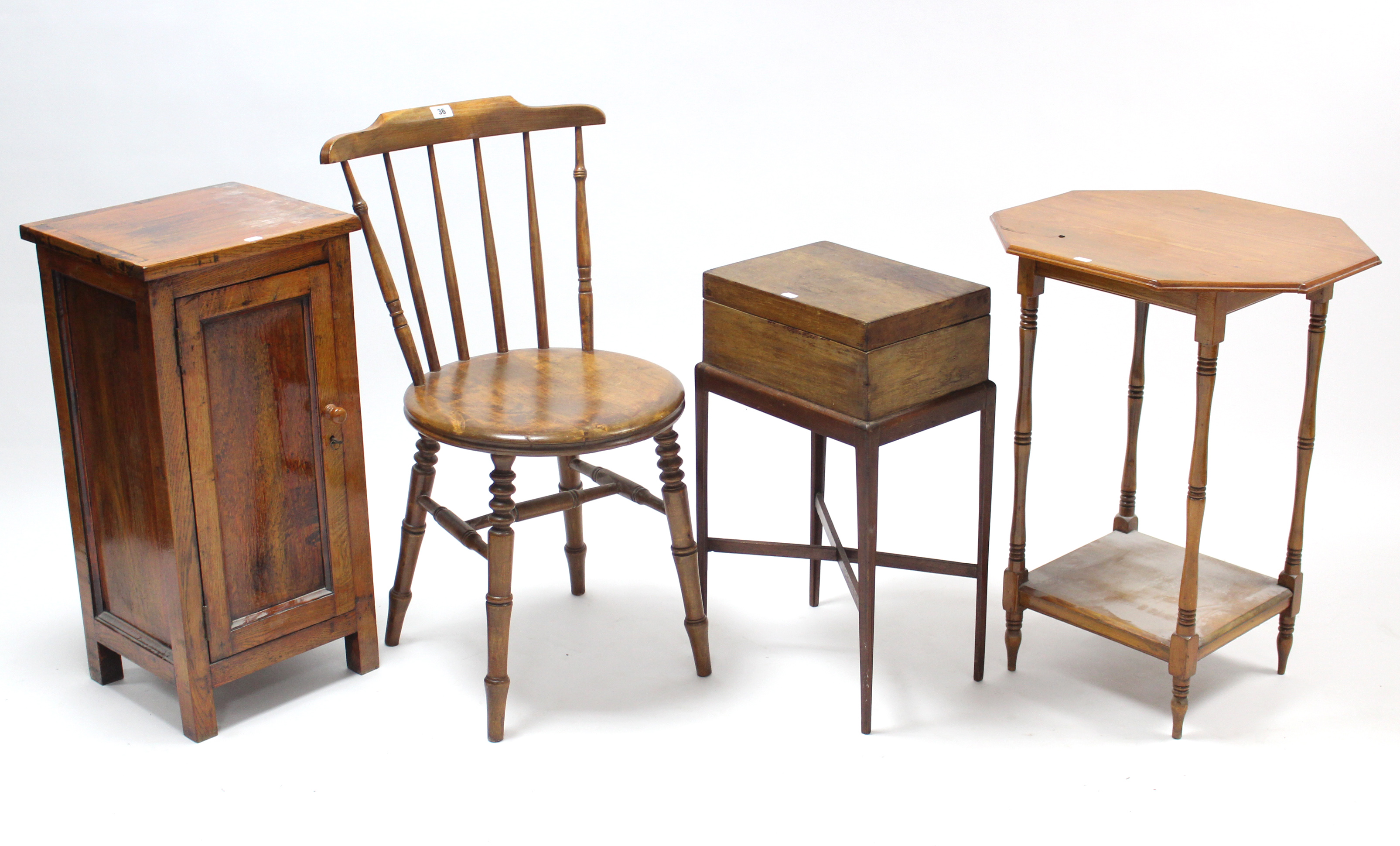 A spindle-back kitchen chair with circular hard seat, & on turned legs with spindle stretchers;
