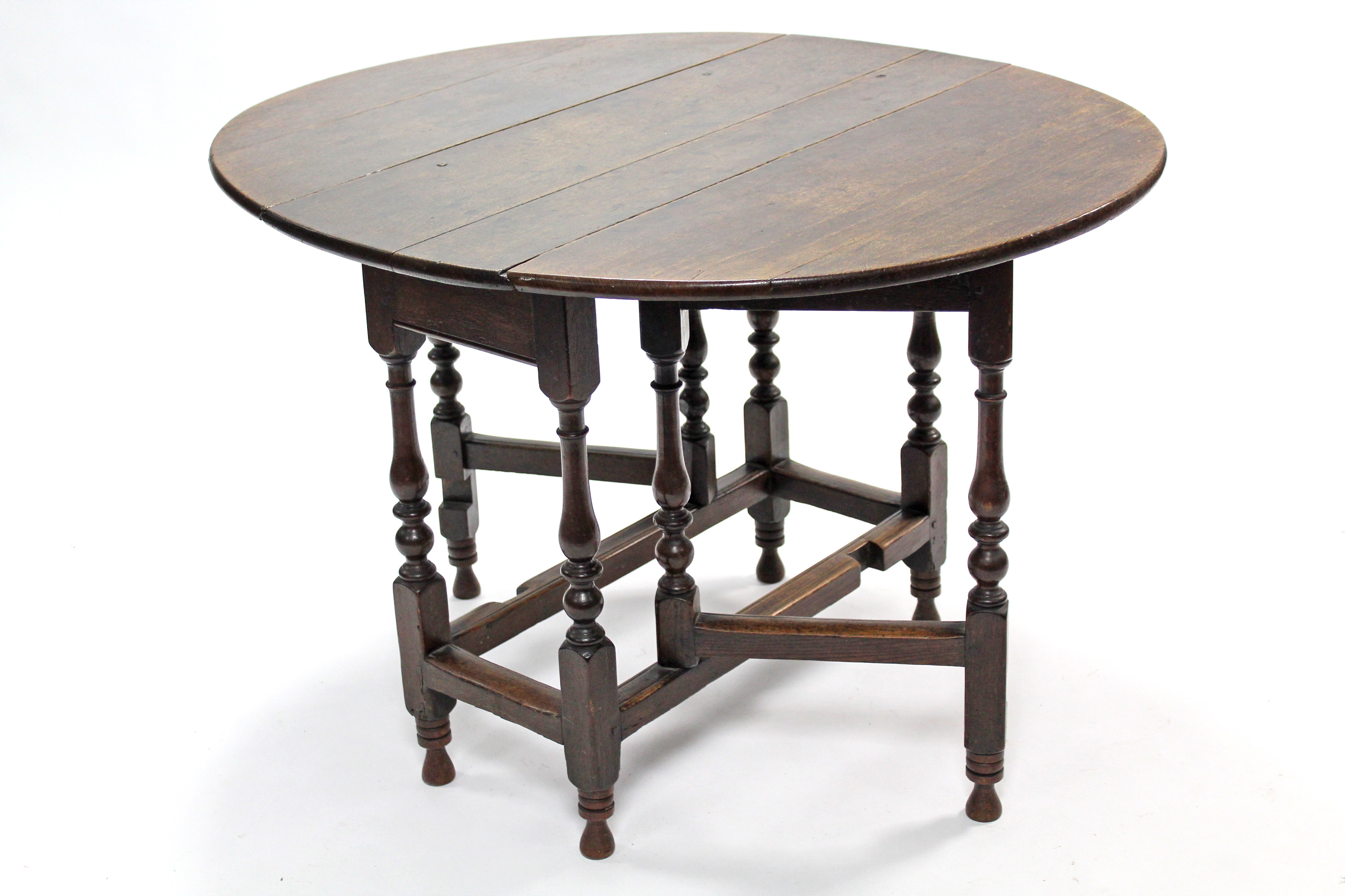 An 18th century oak gate-leg table with oval top, on slender turned supports with plain - Image 2 of 2