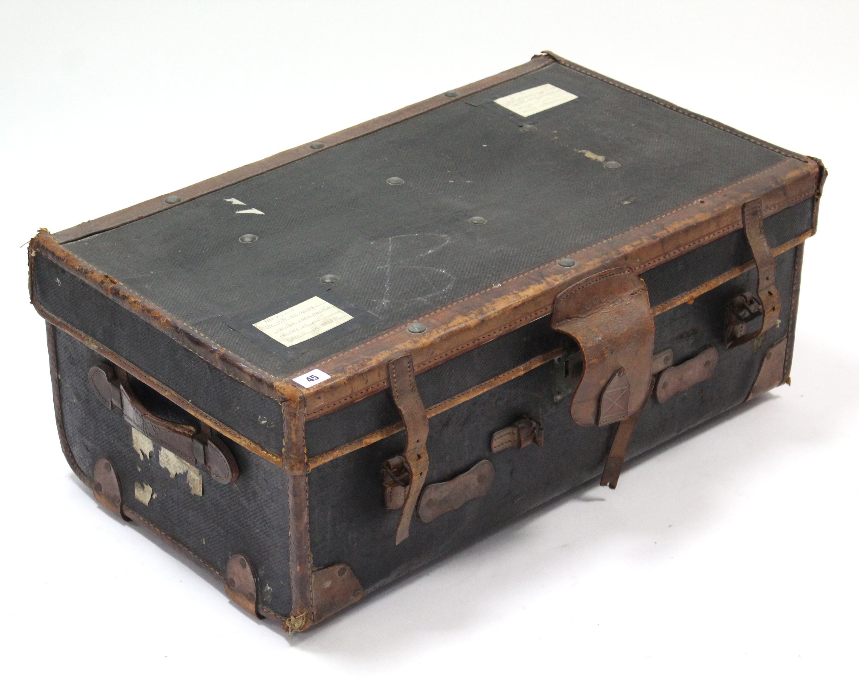 An early 20th century black fibre-covered & leather-bound travelling trunk with hinged lift-lid &