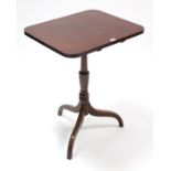 A Victorian mahogany tripod table with rounded corners to the rectangular tilt-top, & on vase-turned