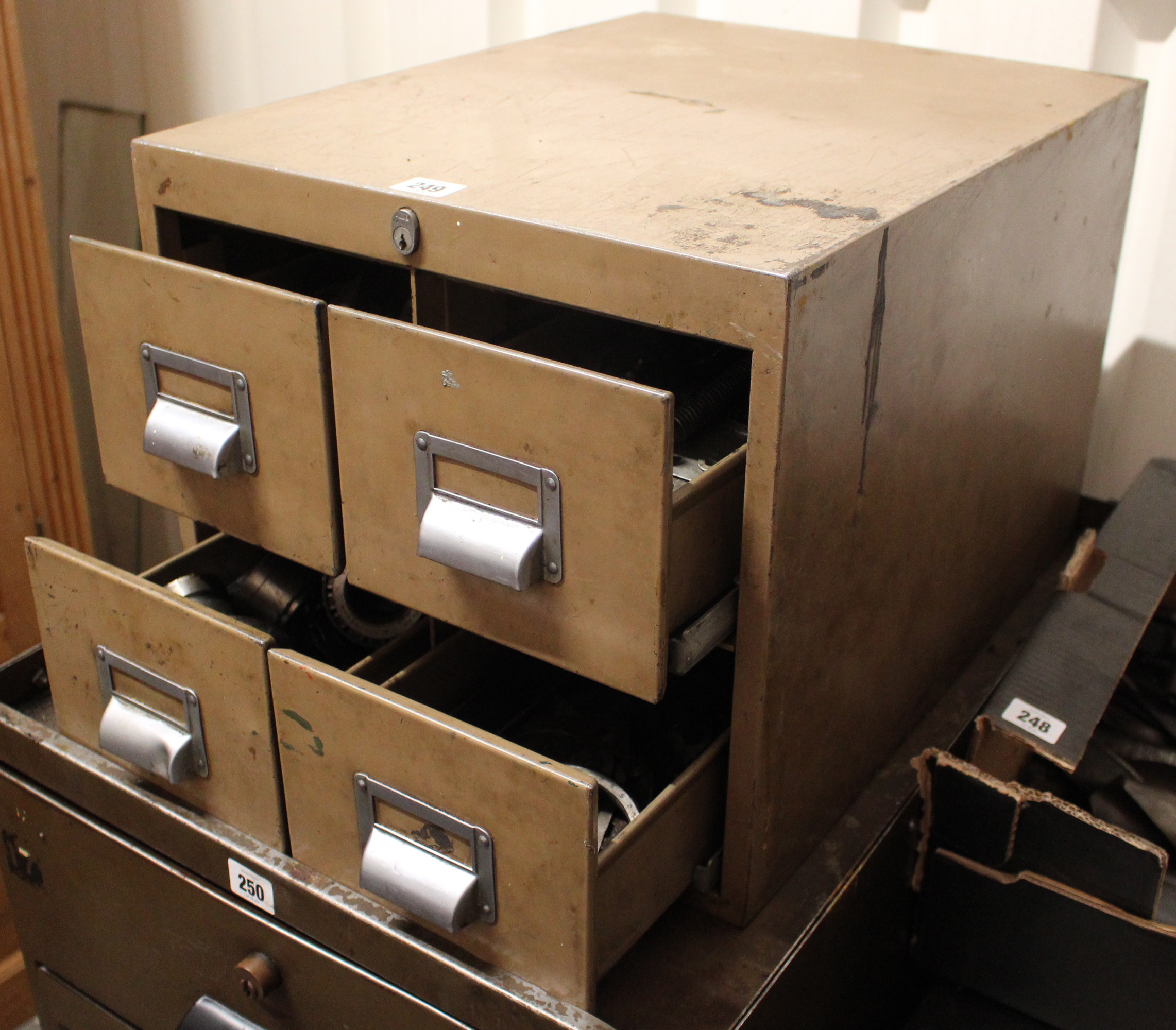 A light brown art-metal counter top chest, fitted two ranks of two short drawers, 15¾” wide x 13½”