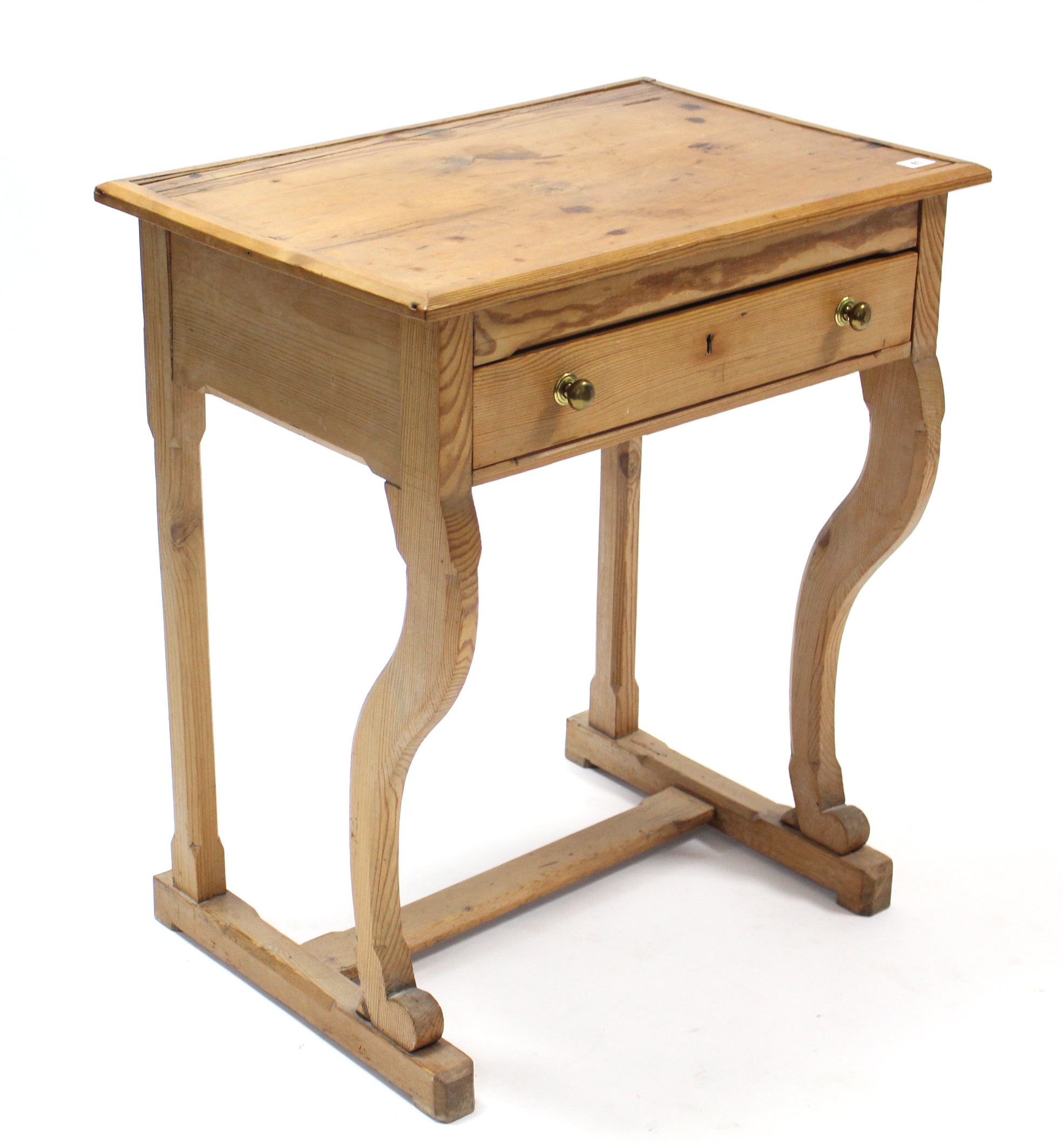 A pine child’s desk with hinged lift-lid, fitted frieze drawer, & on shaped front legs with plain