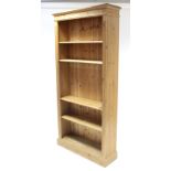 A pine tall standing open bookcase with four adjustable shelves, & on plinth base, 37¾” wide x