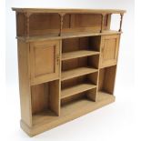 A late Victorian pine side cabinet fitted with an arrangement of open shelves & with a pair of end