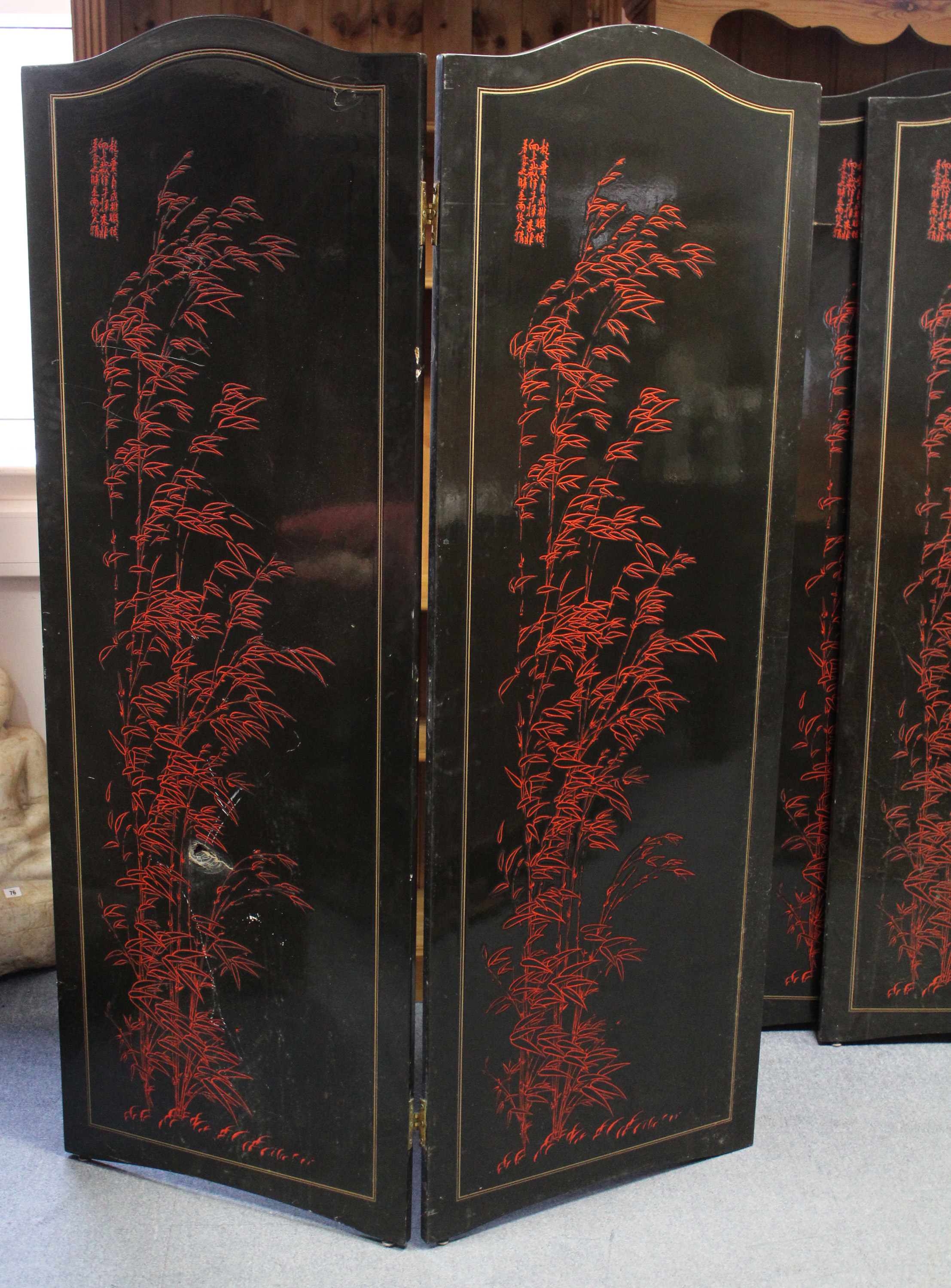 An oriental black & red lacquered four-fold draught screen, 66½” high w.a.f.; & a cloth-covered - Image 2 of 3