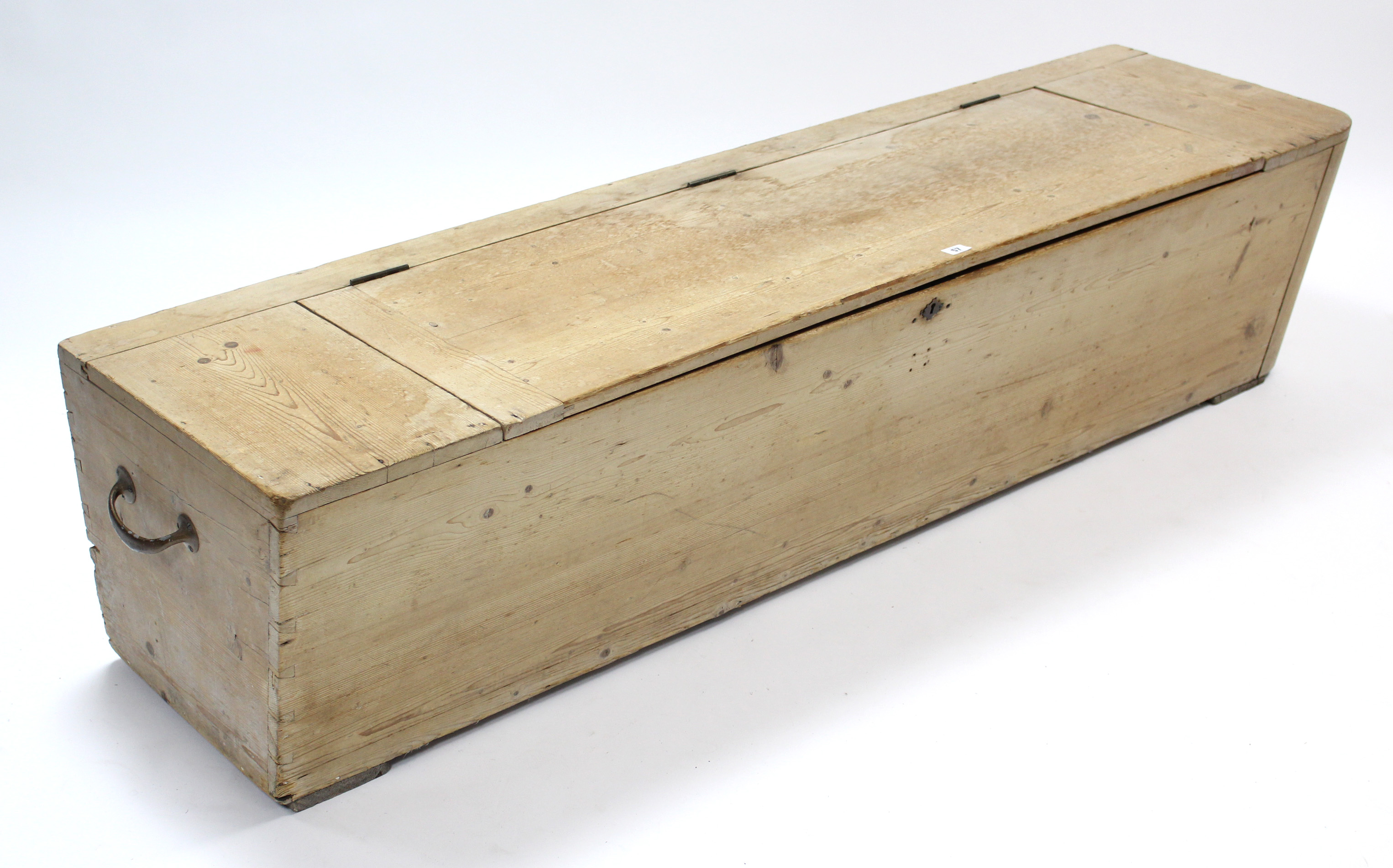 A large pine storage trunk with hinged lift-lid, & with brass side handles, 68” long x 16¼” high.