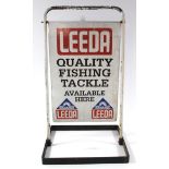 A double-sided sign “LEEDA QUALITY FISHING TACKLE AVAILABLE HERE”, 24” x 16”, on stand.