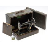 A Singer hand sewing machine with fibre-covered case; & a one-piece snooker cue with japanned-