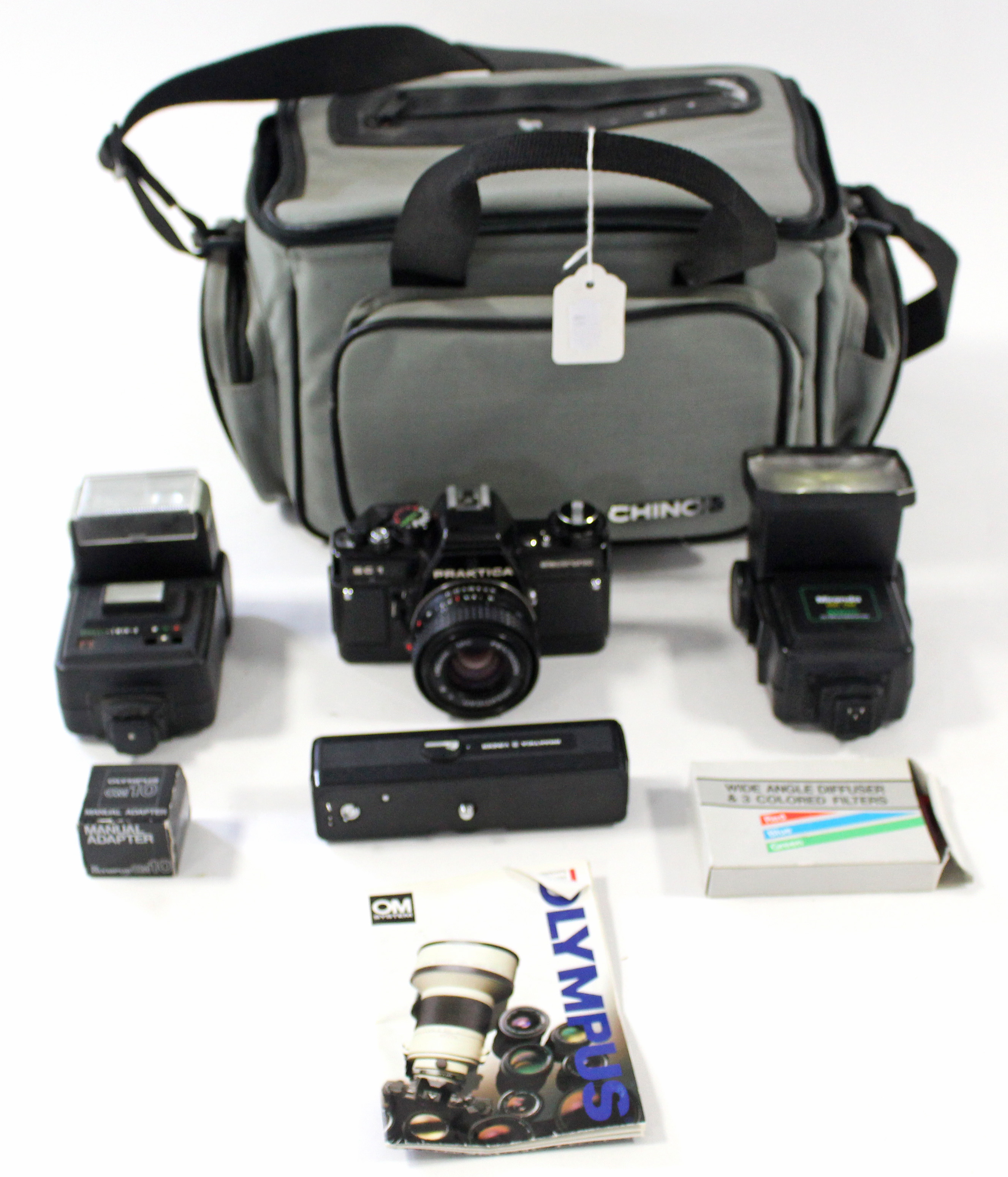 An Olympus “OM10” 50mm camera; & a Praktica “BC1” 50mm camera, each with accessories & case
