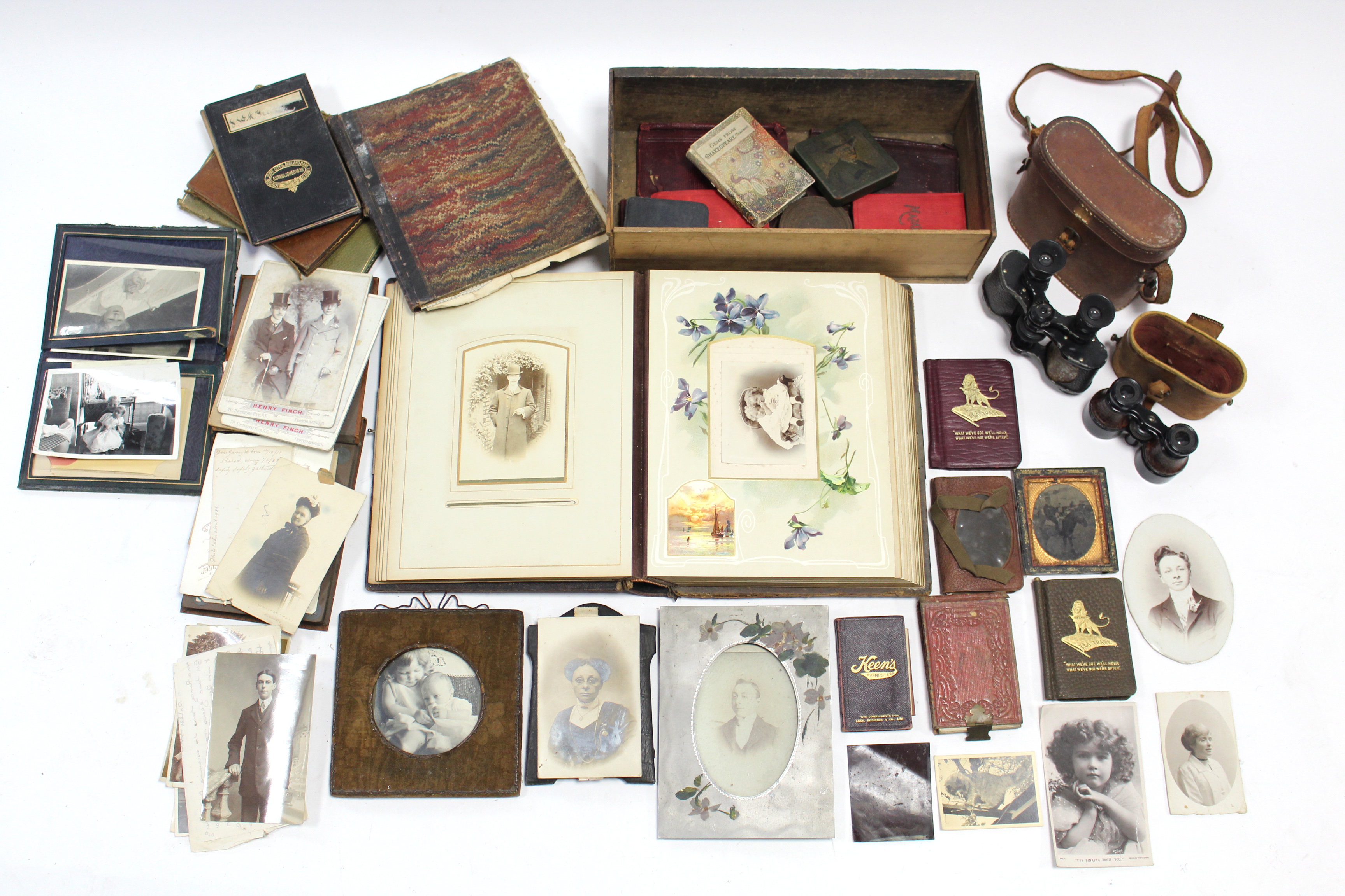 Various family photographs contained in three albums & loose; a pair of binoculars; a pair of