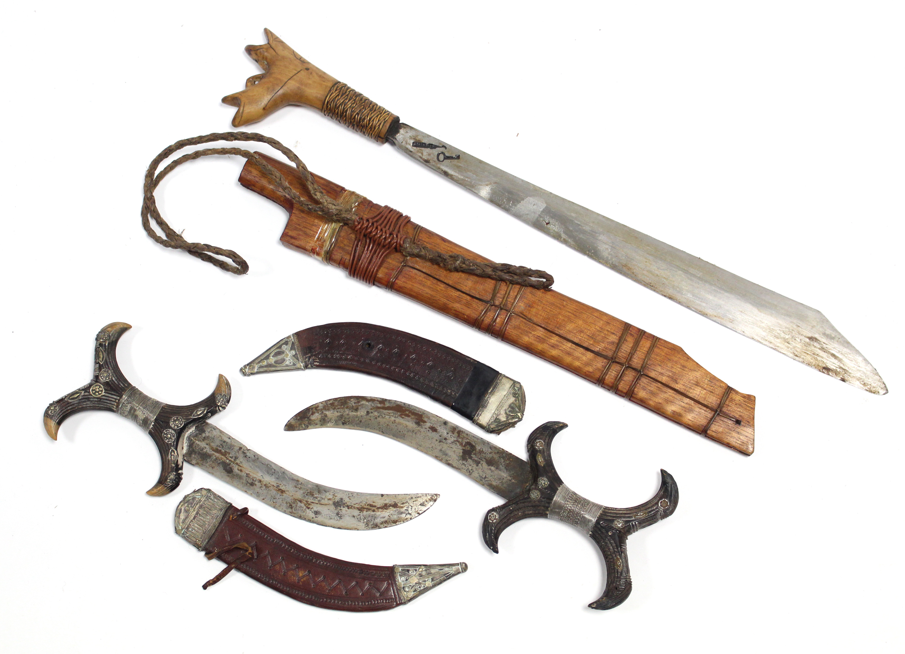 Three Eastern knives each with sheath.