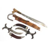 Three Eastern knives each with sheath.