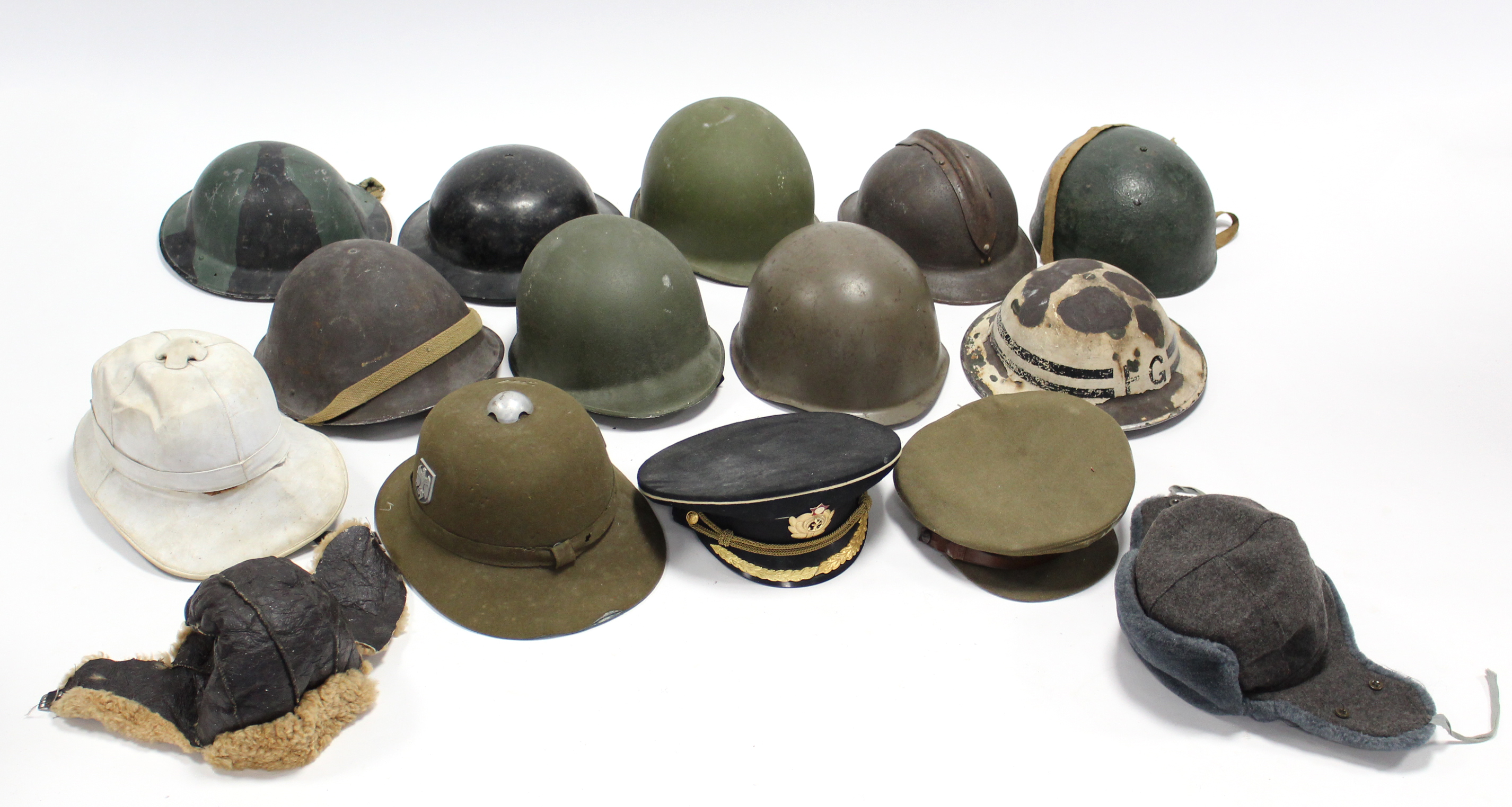 Seventeen various military helmets, caps, etc.
