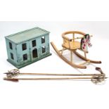 A pair of bamboo ski-poles; a painted wooden child’s rocking horse; & a dolls house.