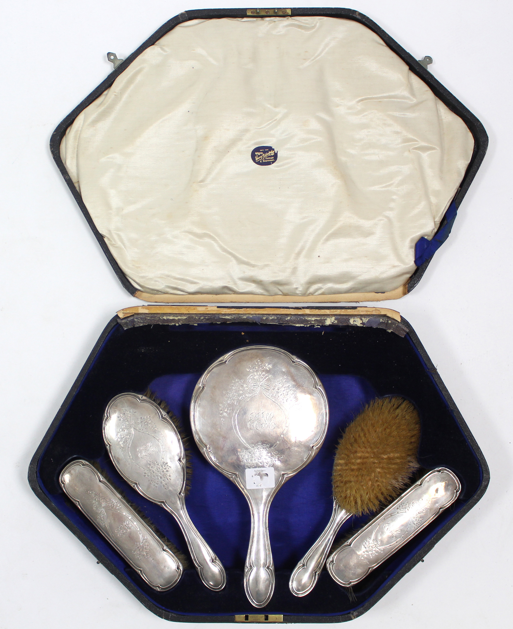 A George V silver-backed five-piece dressing table set, Birmingham 1916, cased.