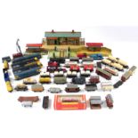 Various tinplate model stations; numerous items of rolling stock, track, etc., all unboxed.