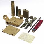 A WWII canvas map holder (1945); a ditto “First Aid” bag; two brass shell cases; a leather covered
