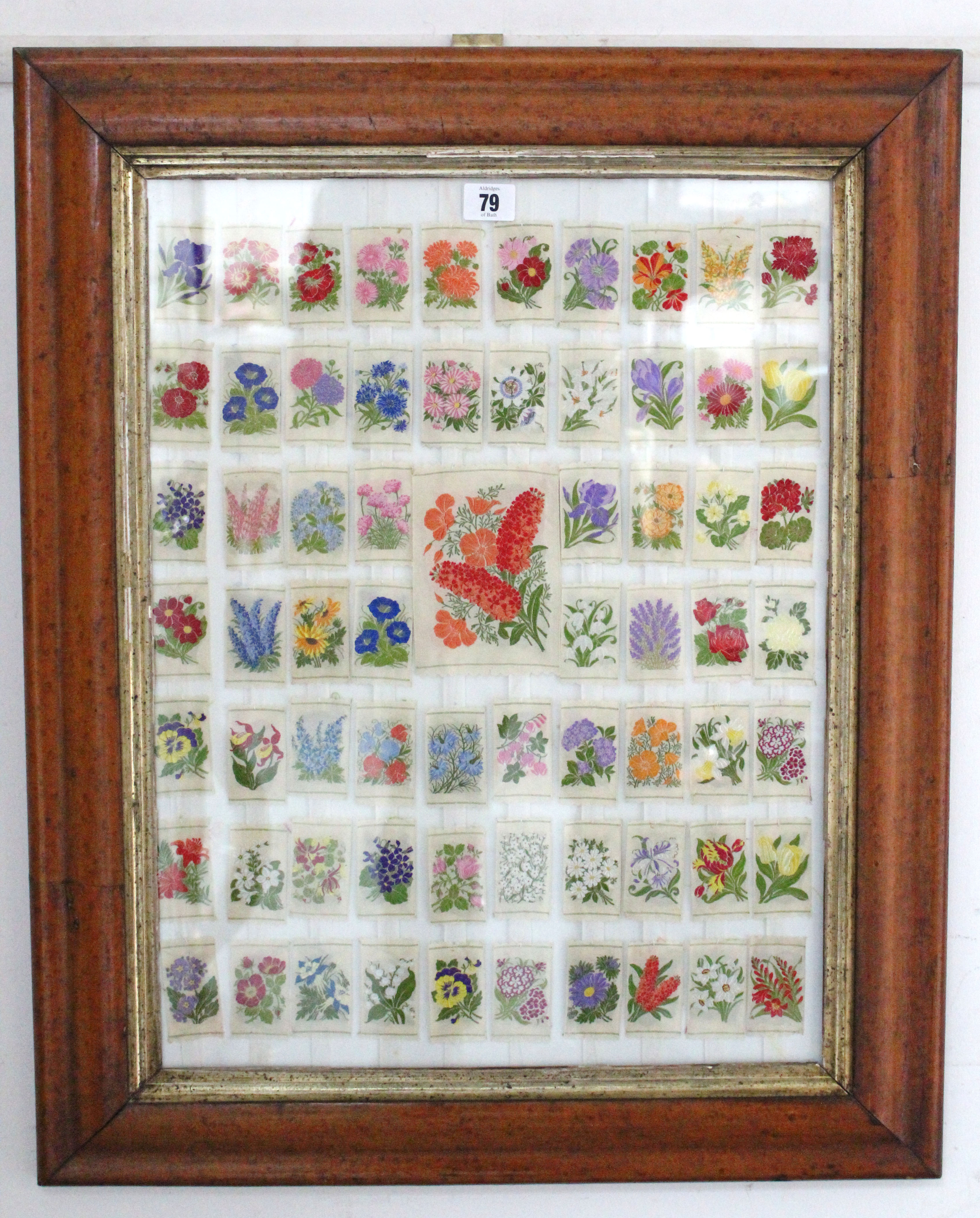 A display of silk “floral” trade cards in a glazed bird’s-eye maple frame.