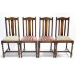A set of four 1930’s oak rail-back dining chairs with padded drop-in seats, & on barley-twist legs