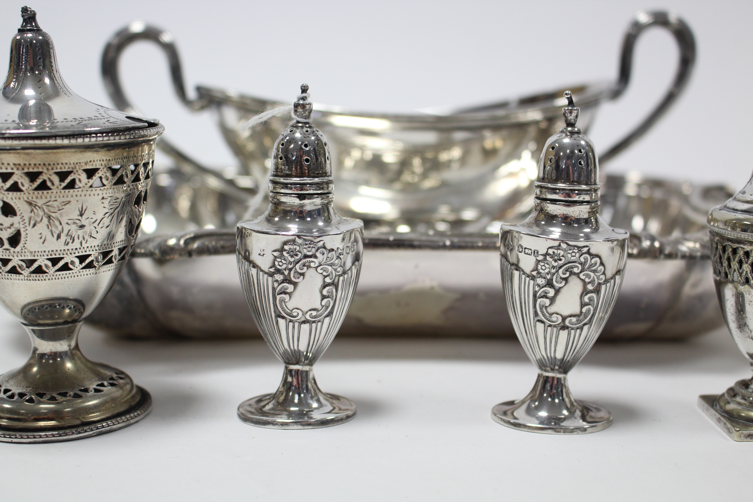 A pair of silver pepper pots, 3¾” high; & various items of platedware