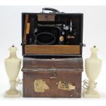 A Singer hand sewing machine with blue fibre-covered case; a grained tin domed-top trunk, 18”