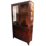 A Chinese carved hardwood tall china display cabinet, the upper part fitted two plate-glass