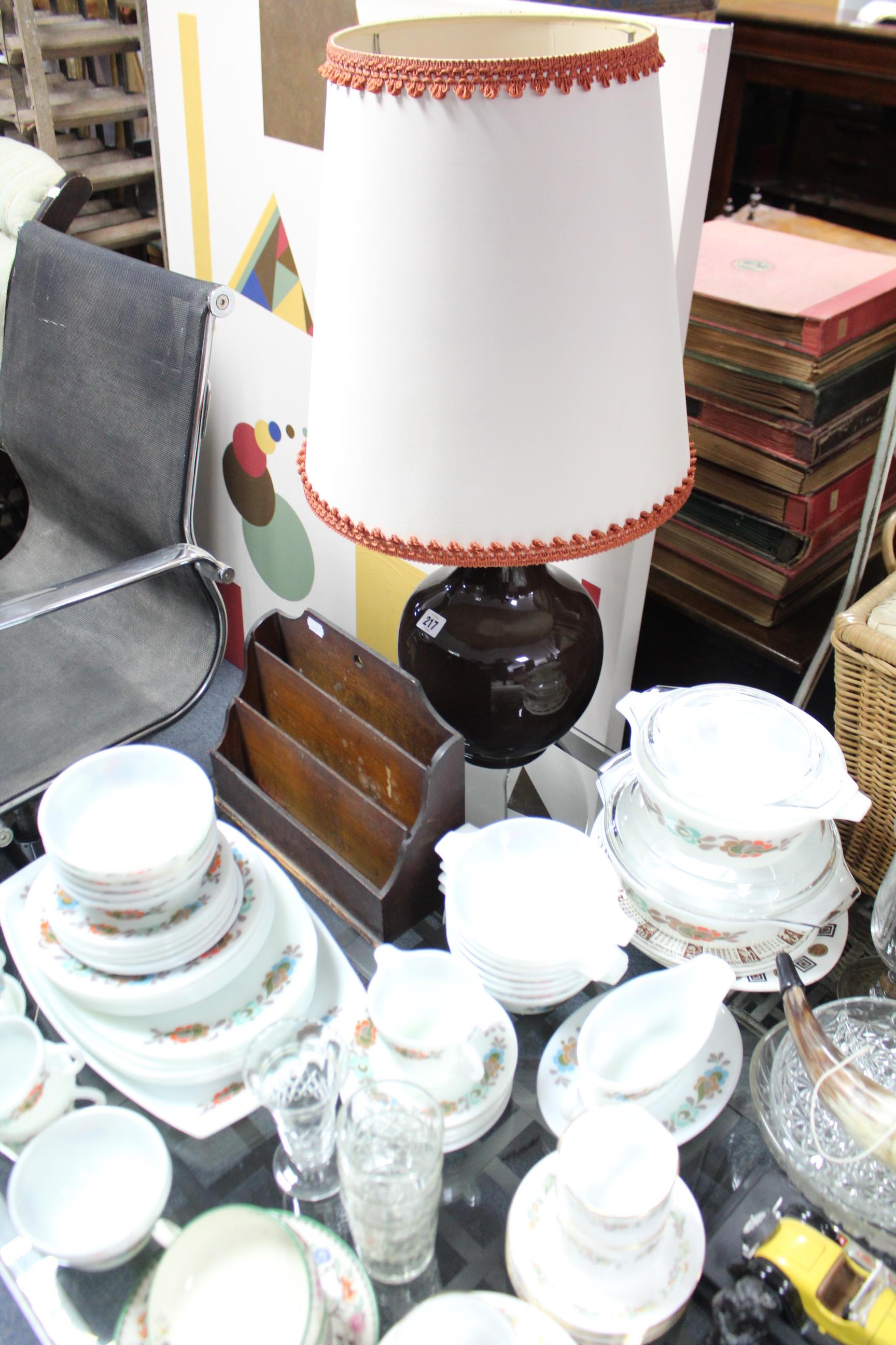 Two heavy cut-glass decanters; a pottery table lamp with shade; a floral decorated part tea service,