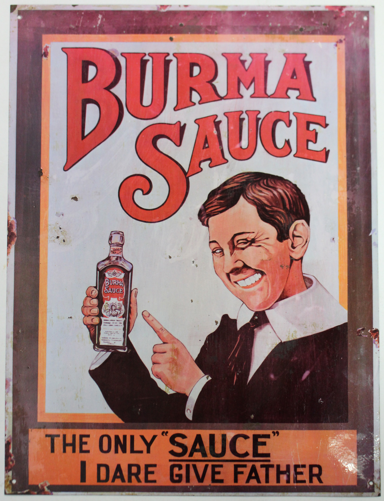 A reproduction of a “Burma Sauce” enamel trade sign, 23½” x 17¾”.