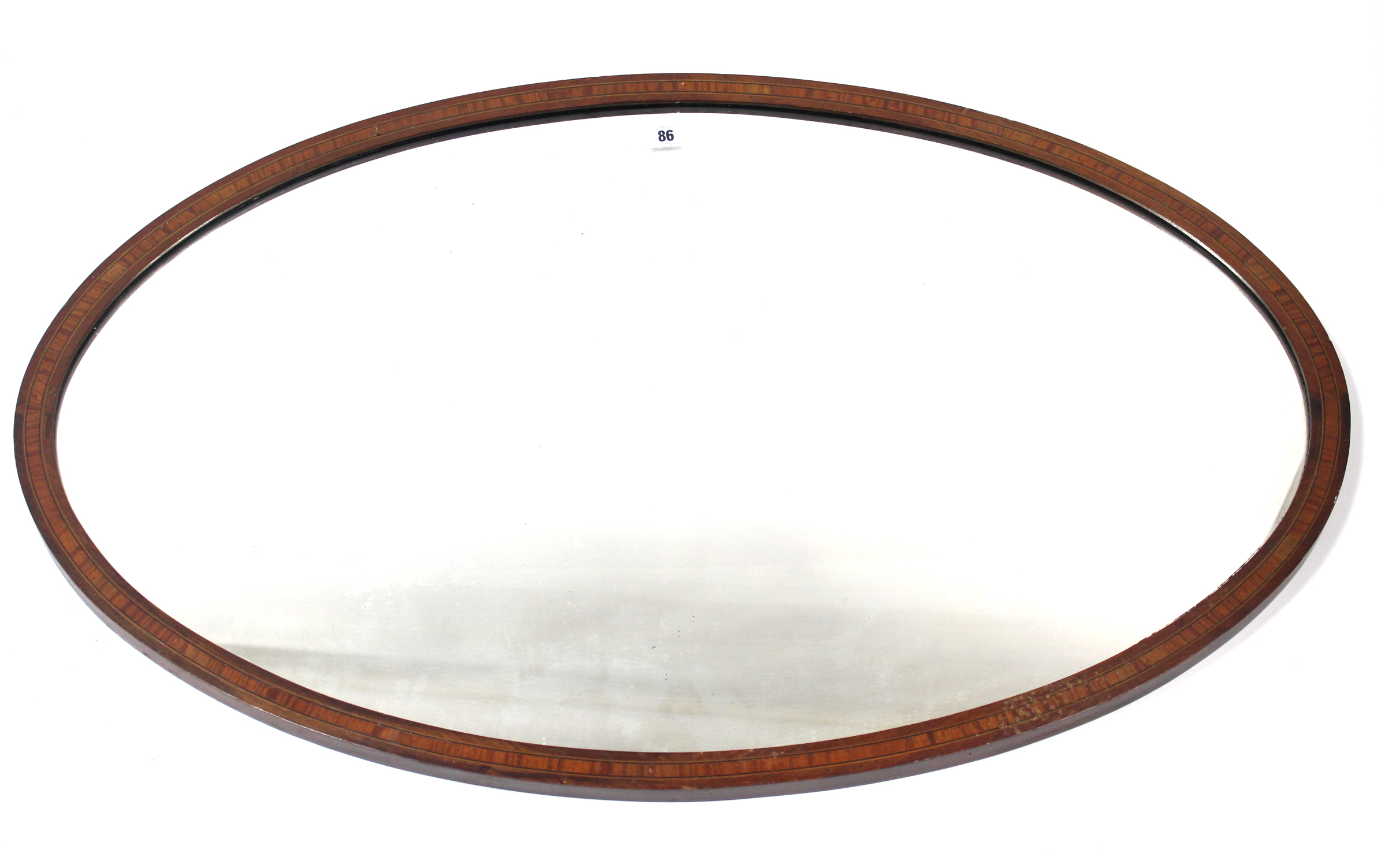 An Edwardian inlaid mahogany frame oval wall mirror, 23½” x 37½”; together with an Edwardian box-