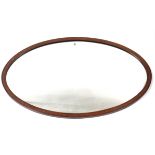 An Edwardian inlaid mahogany frame oval wall mirror, 23½” x 37½”; together with an Edwardian box-