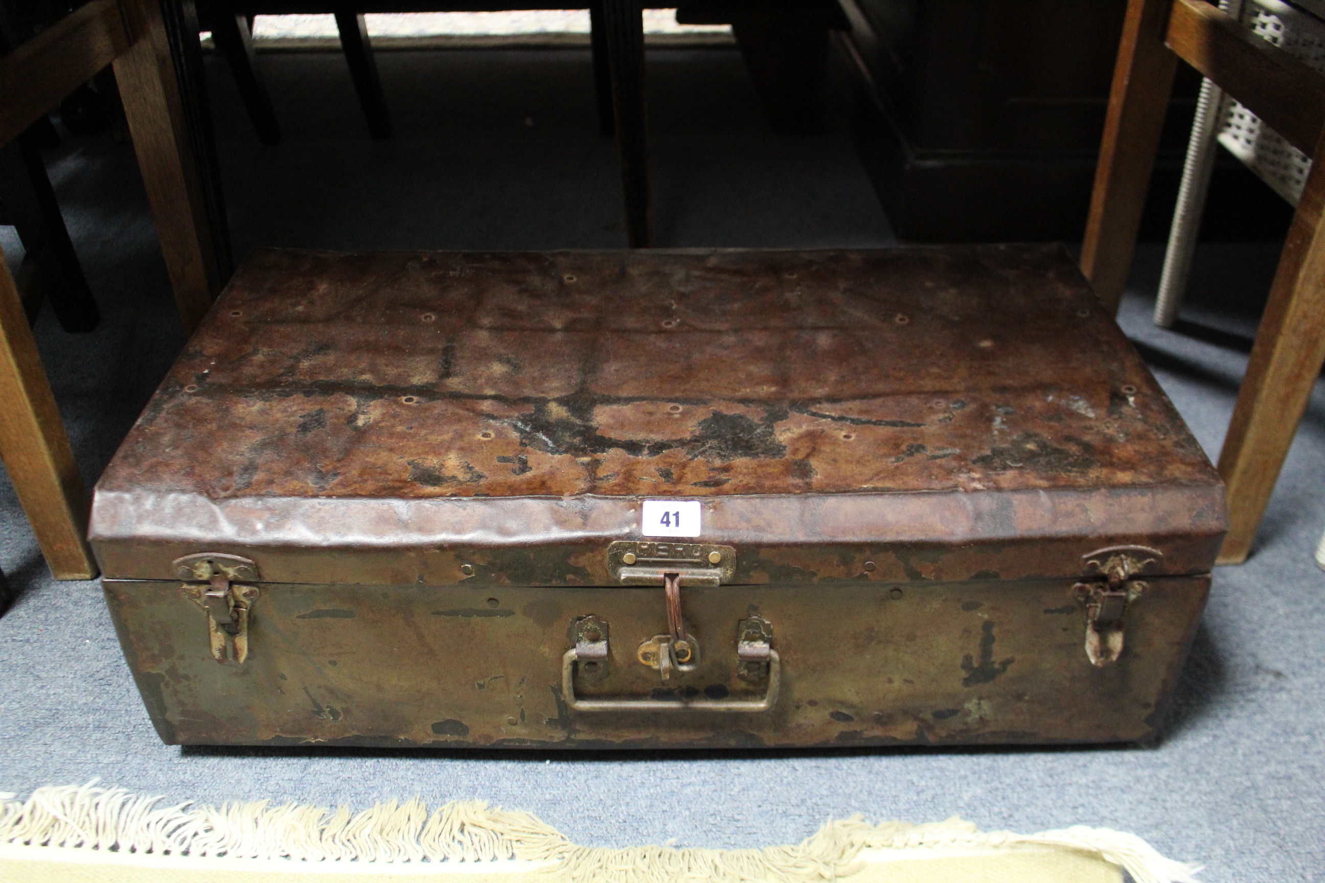 A steel travelling trunk with hinged lift-lid, 25” wide.