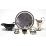 A George V silver tea-strainer, Birmingham 1925; a silver-plated ditto; a silver-plated helmet-