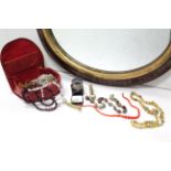 An oval wall mirror in mahogany & gilt frame, 21” x 24”; together with a silver napkin ring; a