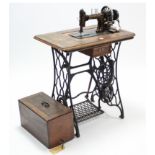 An early 20th century Frister & Rossmann treadle sewing machine in inlaid-walnut case, & on black