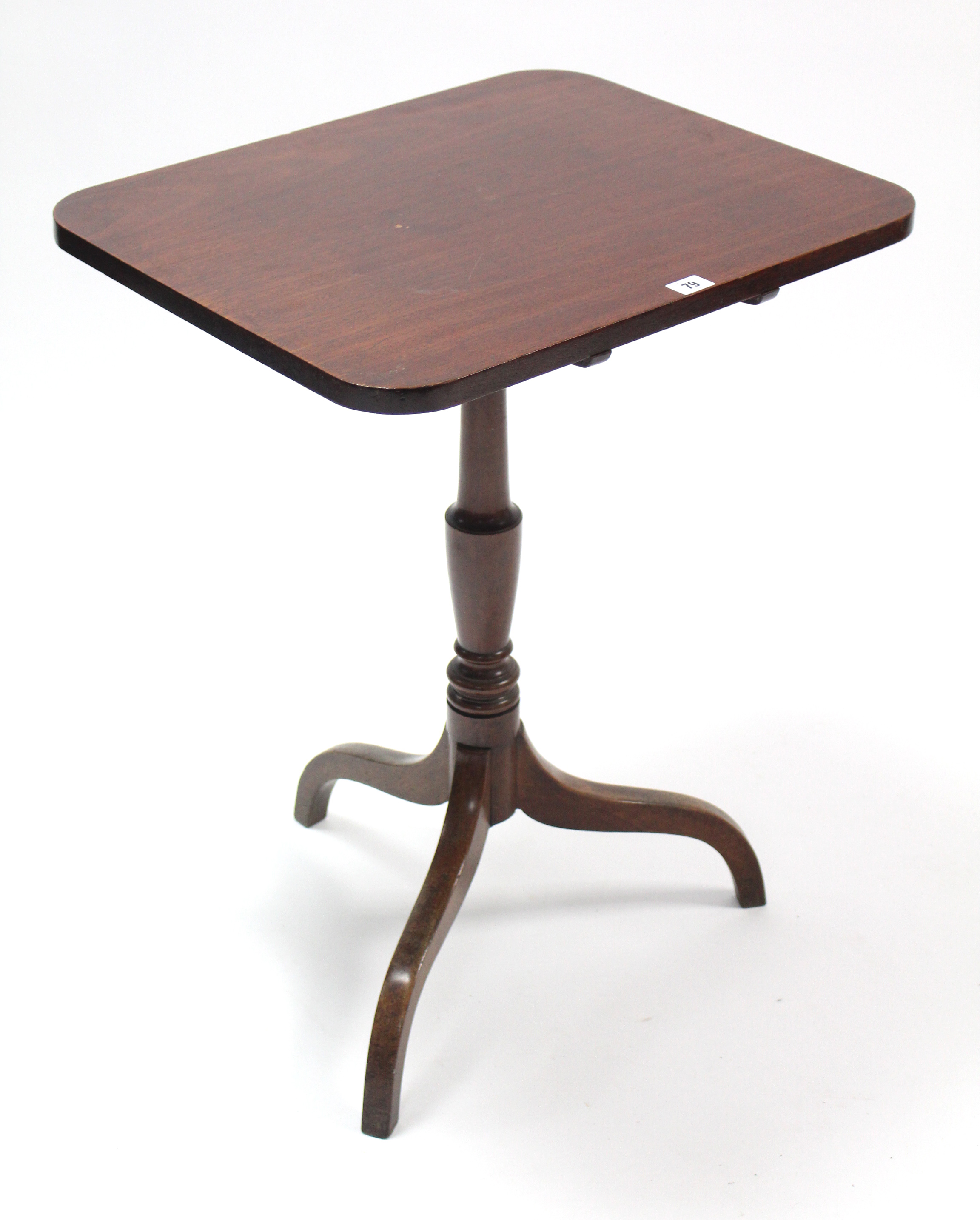 A Victorian mahogany tripod table with rounded corners to the rectangular tilt top, & on vase-turned