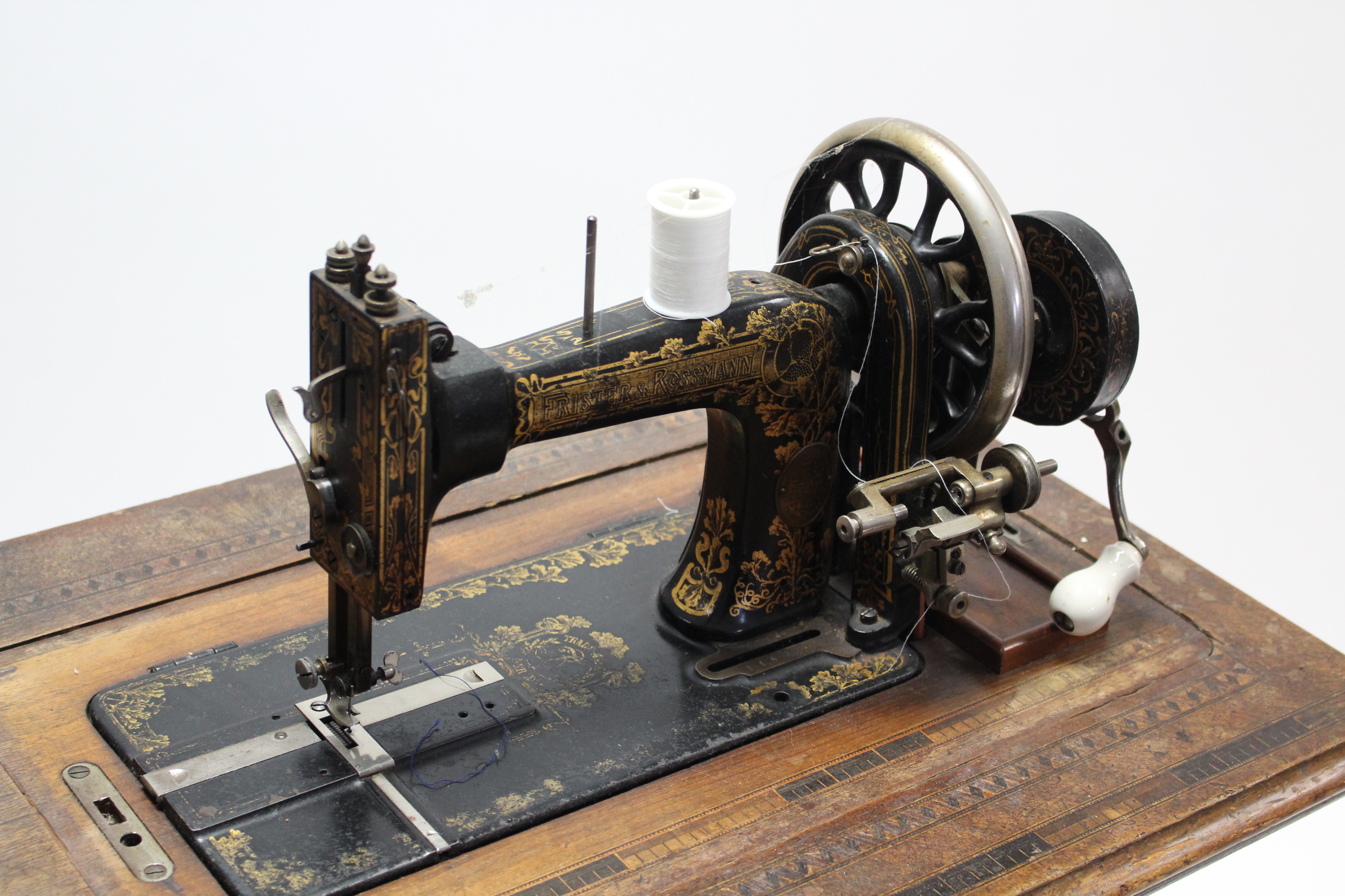 An early 20th century Frister & Rossmann treadle sewing machine in inlaid-walnut case, & on black - Image 2 of 4