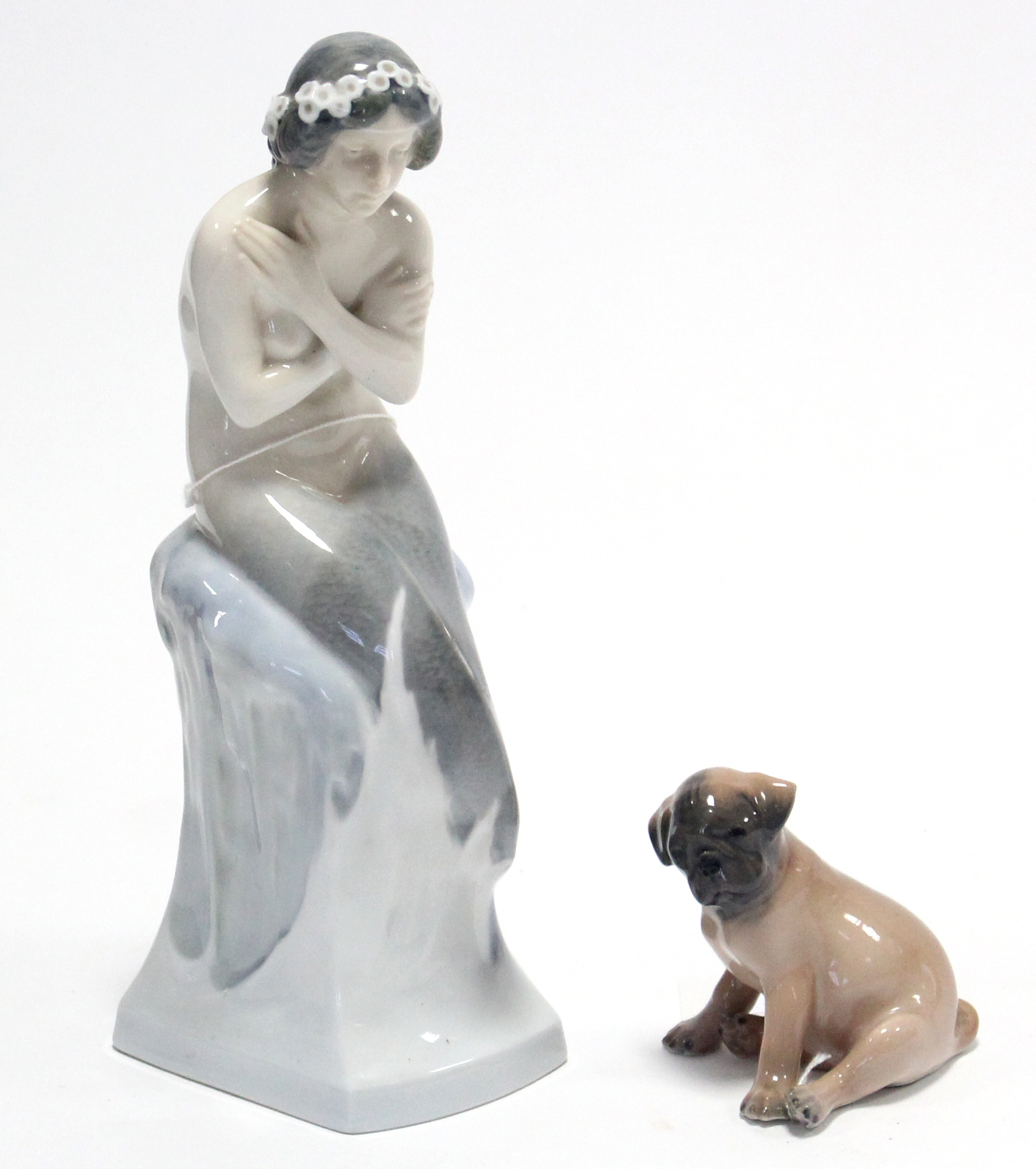 A Royal Copenhagen porcelain ornament in the form of a mermaid seated on an ice rock (No.1210),