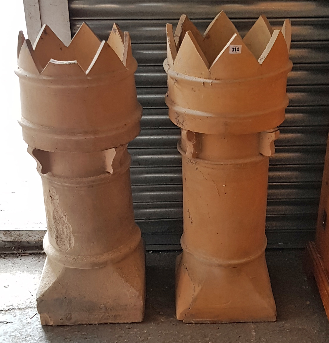 A pair of terracotta chimney pots (w.a.f.), 37½” high.