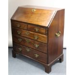 A Georgian mahogany bureau with fitted interior enclosed by fall-front above two short & three