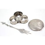 A Dutch silver serving fork; a sterling circular powder compact with engraved map of India; &