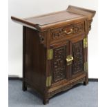 A Chinese carved teak side cabinet, fitted frieze drawer above cupboard enclosed by pair of panel