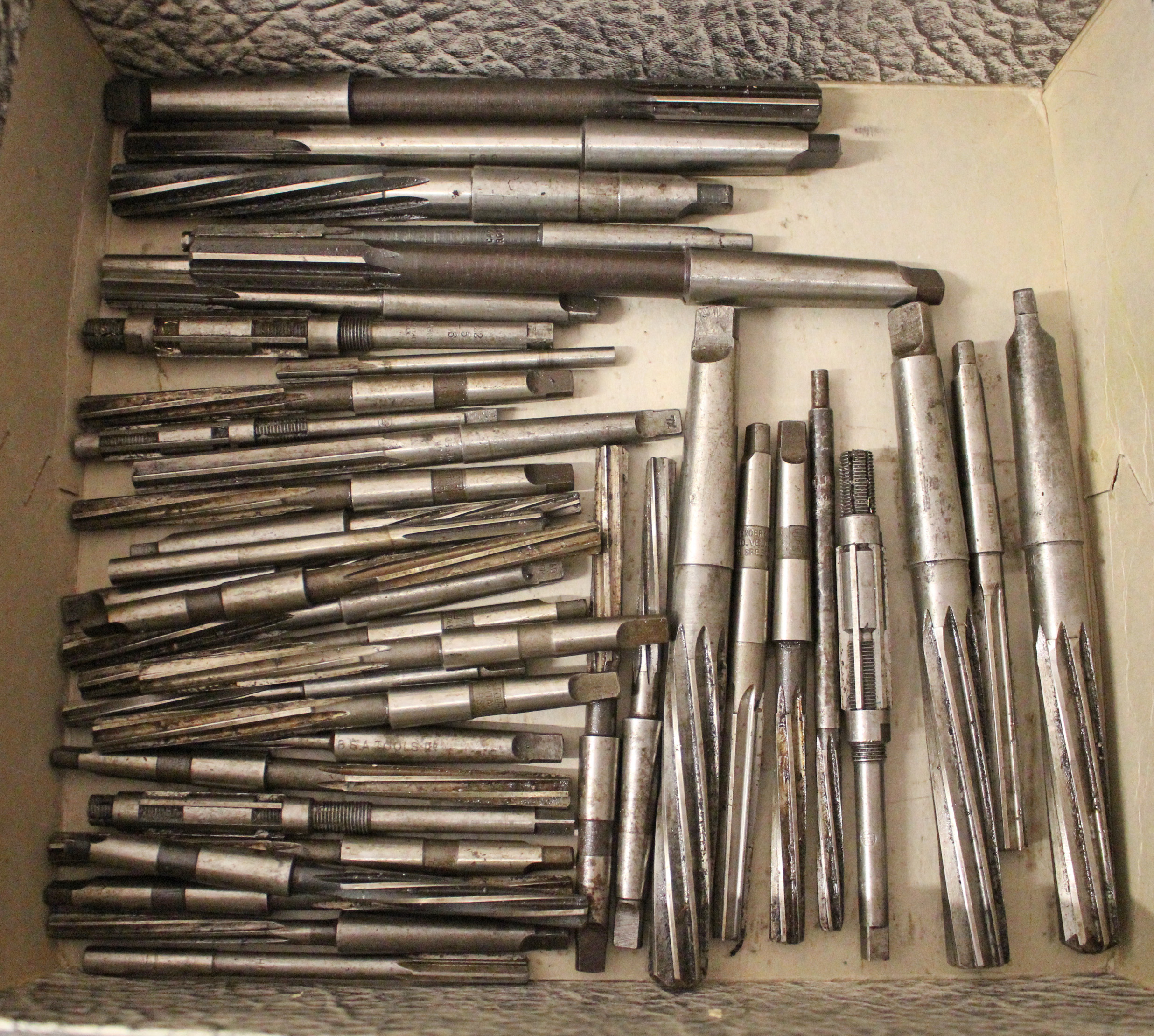 A collection of forty precision reamers.