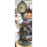 A Juliana mantel clock with composition figure group centre column & on oval base, 32” high.
