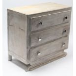A continental-style white painted wooden dwarf chest fitted three long drawers, & on shaped plinth