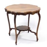 A Victorian mahogany two-tier circular occasional table with shaped moulded top, on carved