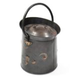 A 19th century Scottish Arts & Crafts coal scuttle of cylindrical form with flared rim, swing