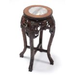 A late 19th/early 20th century Chinese carved hardwood jardineire stand with circular marble top &